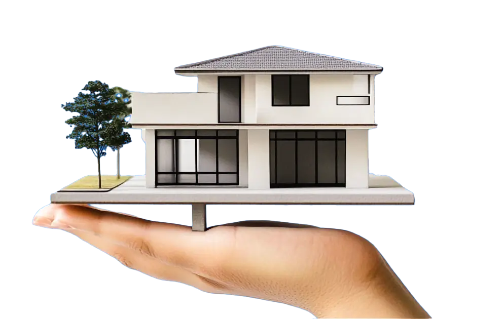 Mano sosteniendo la maqueta de una casa